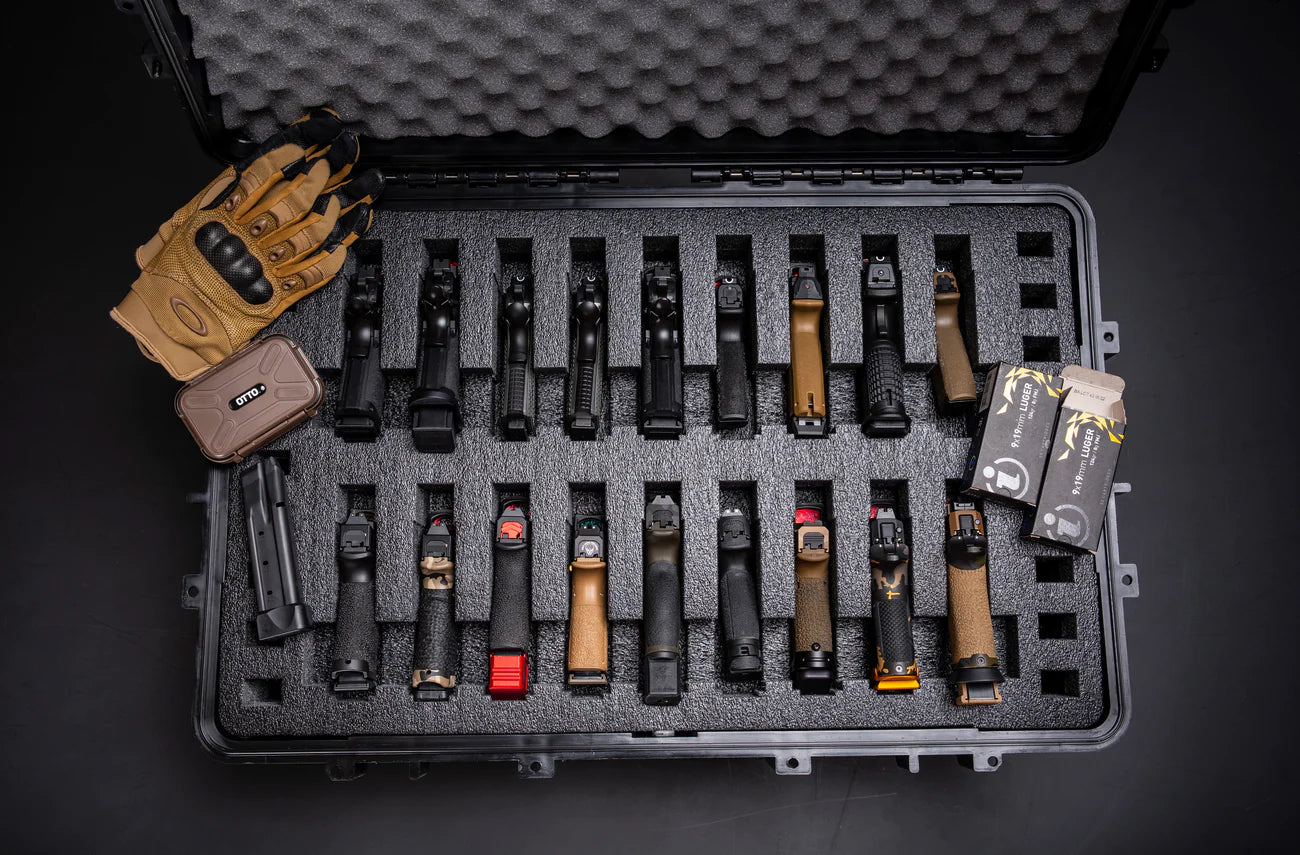 Alt text: "Open black carrying case with 18 pre-cut slots displaying a variety of tactical flashlight holders, magazine carriers, and other accessories, alongside a pair of tactical gloves and boxes of ammunition."