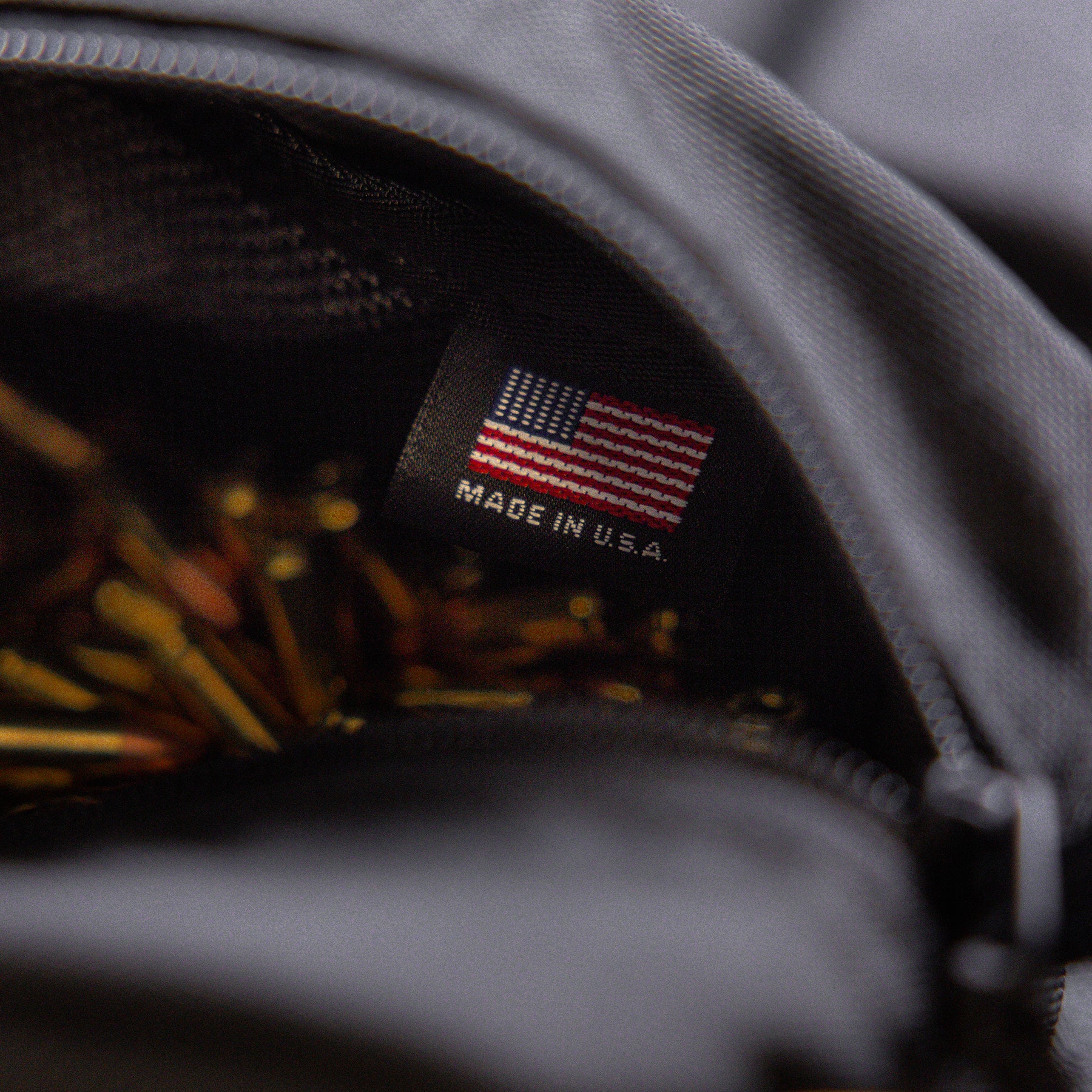 Close-up of a black Lone Star Ammo Bag interior with a label indicating it is made in the USA, partially showing ammunition inside.