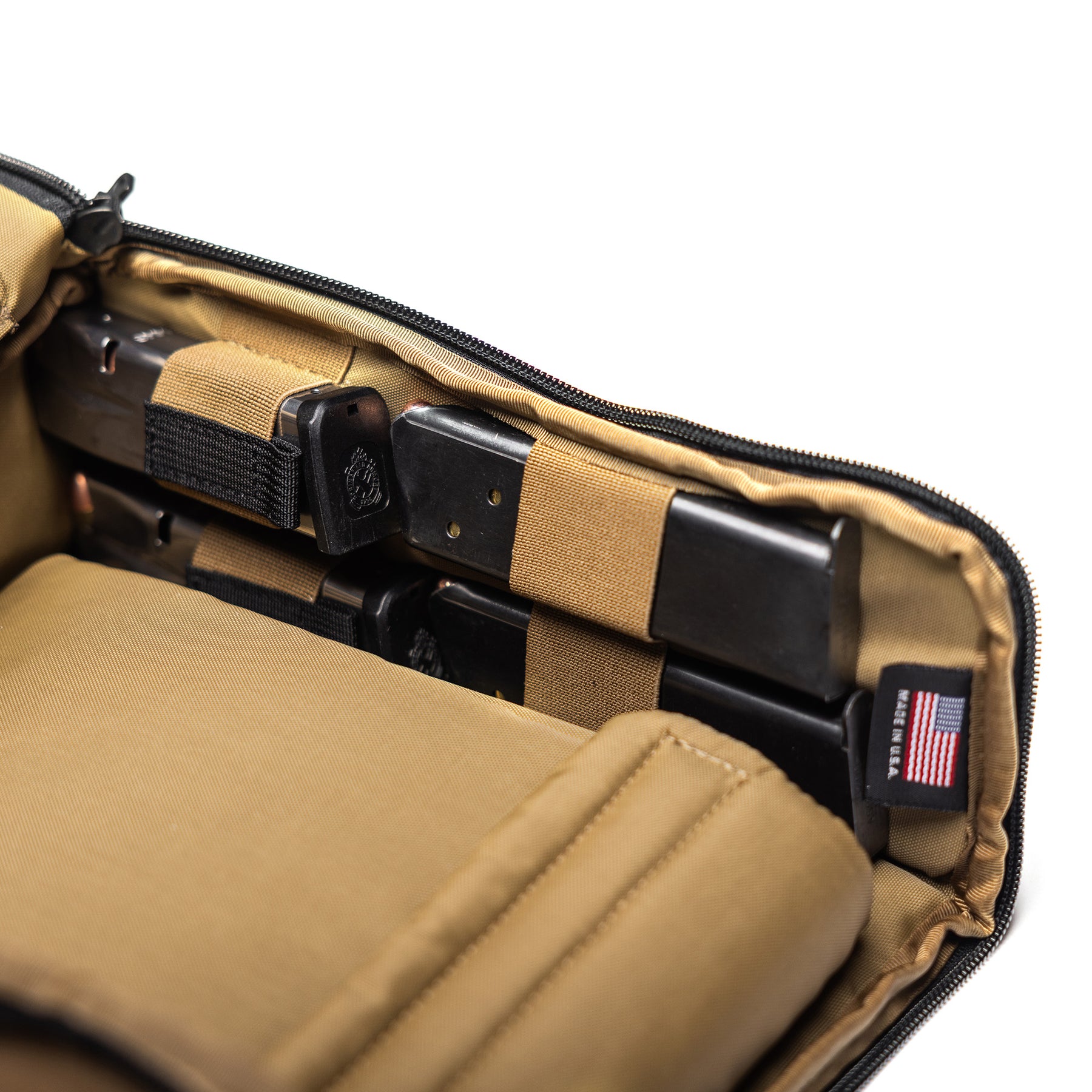 Inside view of the Lone Star 2 Pistol Bag showing secure compartments and elastic straps for firearm storage.