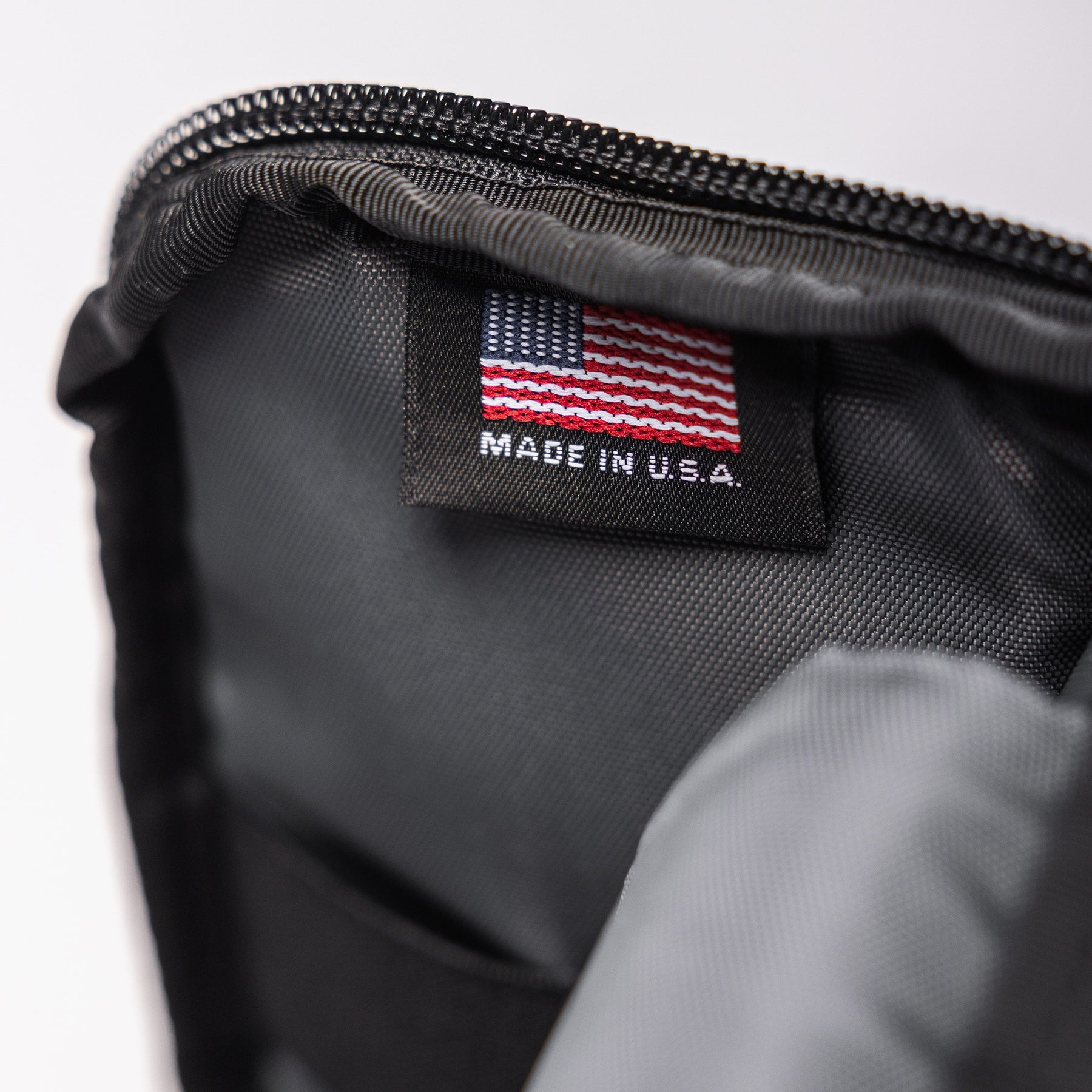 Close-up of the Lone Star 2 Pistol Bag showing a black tag with an American flag and "Made in U.S.A." text inside the bag.