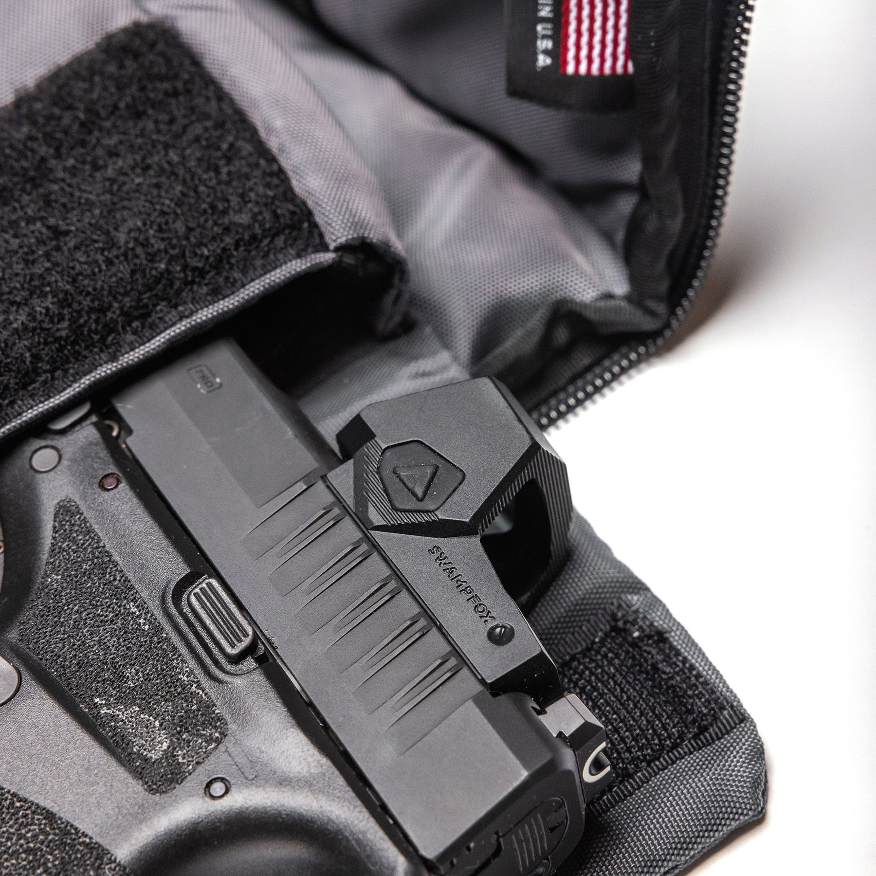 Inside a Lone Star 2 Pistol Bag, a handgun with a mounted sight is securely stored, ready for transport or storage.
