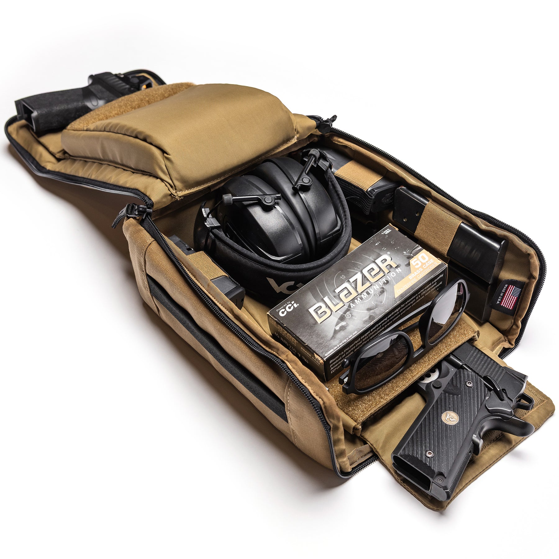 Open Lone Star 2 Pistol Bag with two handguns, ear protection, sunglasses, ammunition box, and accessories inside.