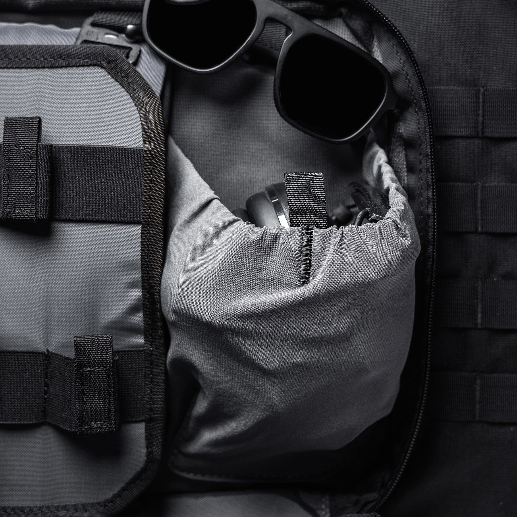 A black and gray Lone Star 36" rifle bag with a zippered compartment, holding sunglasses and a small accessory inside.