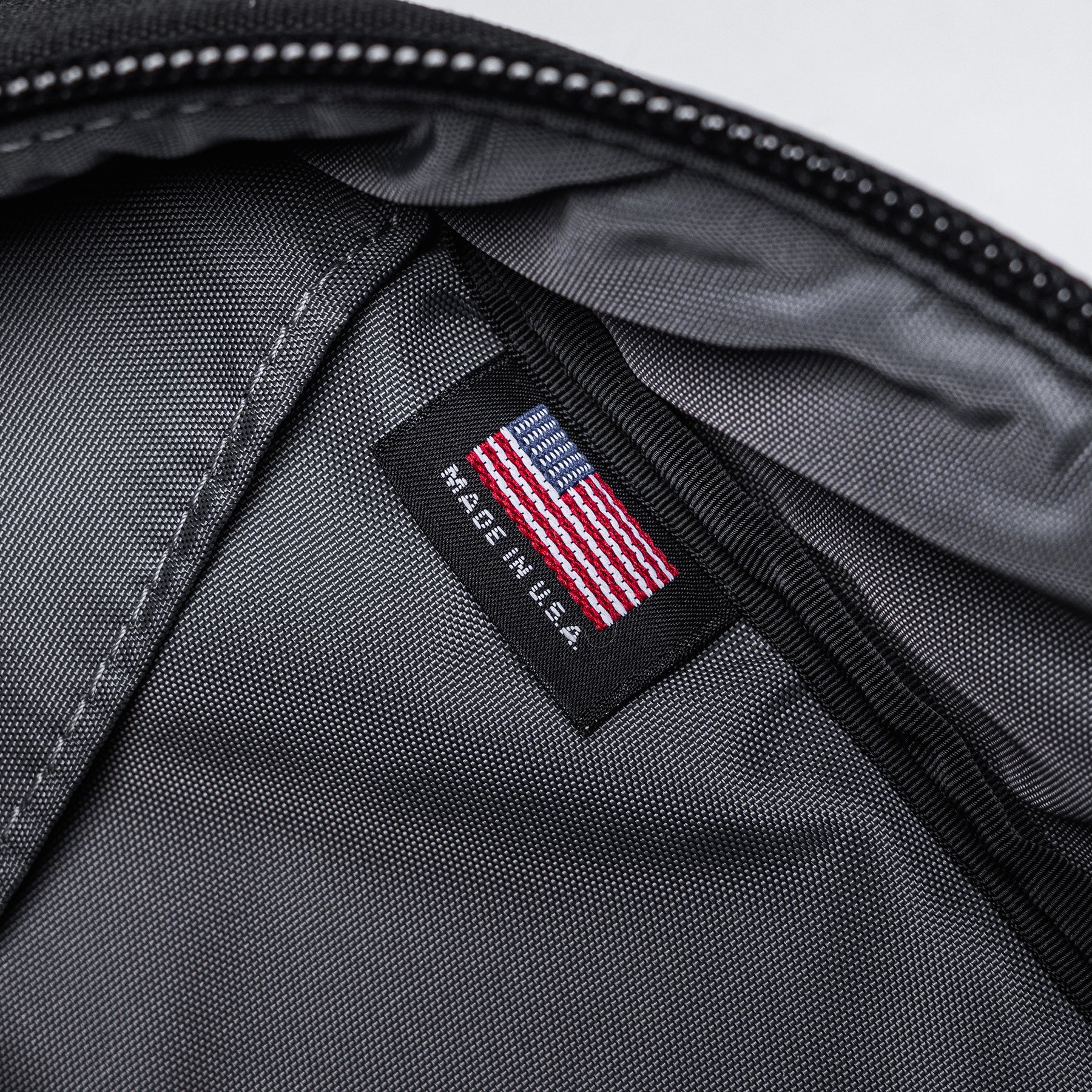 Close-up of the interior of a black Lone Star 36" rifle bag with a US flag label and "Made in U.S.A." tag visible.