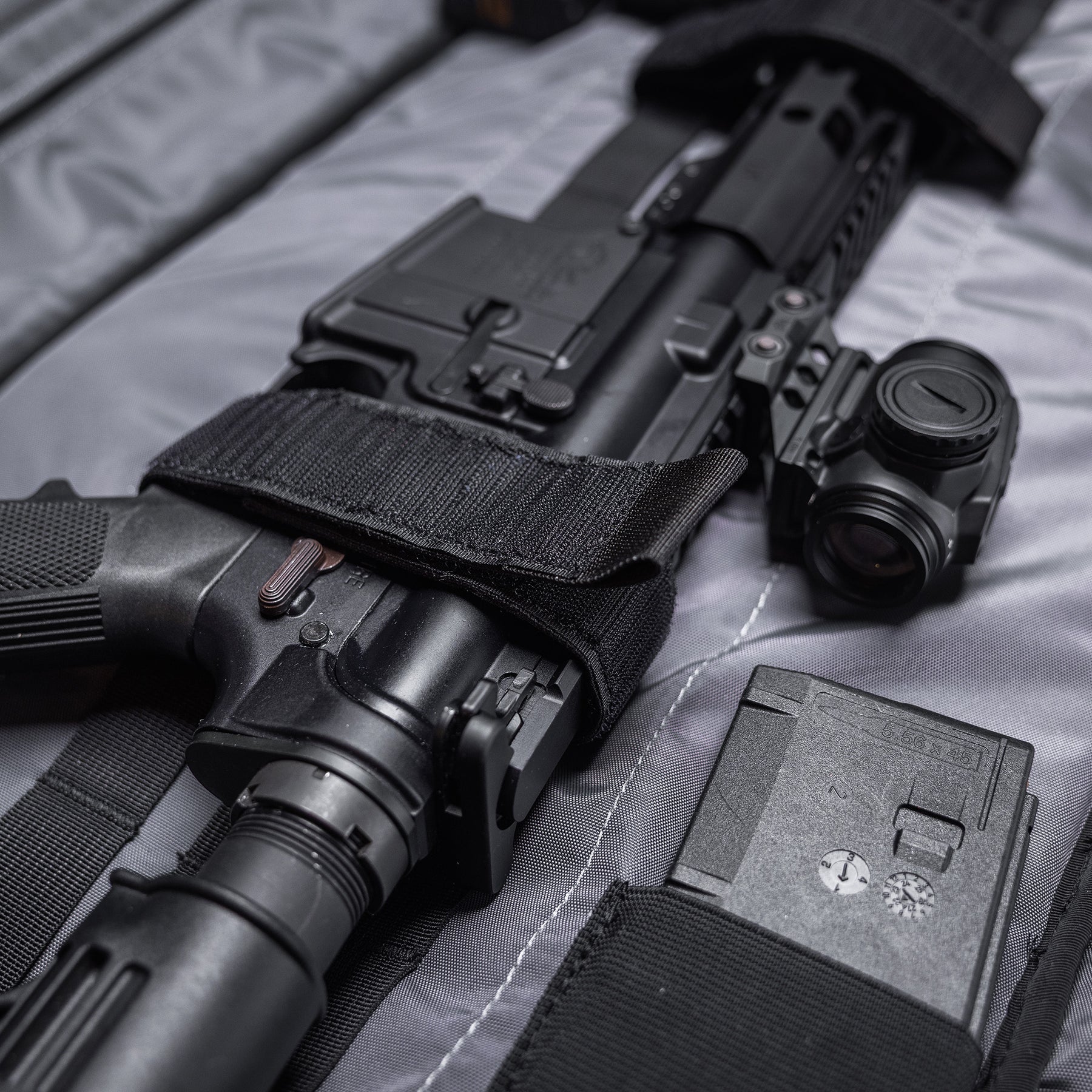 Black Lone Star 36" rifle bag with a firearm, scope, and magazine inside, designed for secure transport and storage.