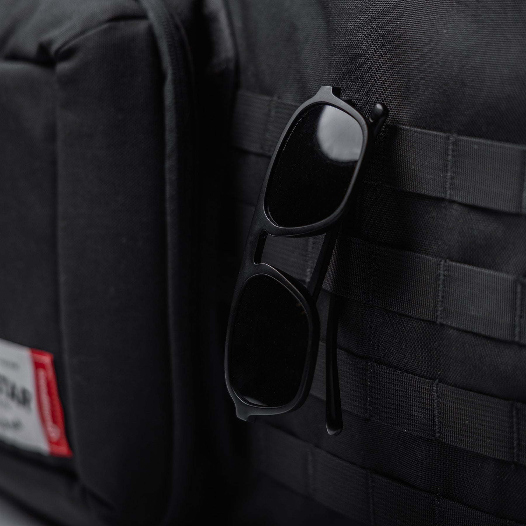Black Lone Star 36" rifle bag with sunglasses attached to the exterior, made of durable fabric with MOLLE webbing.