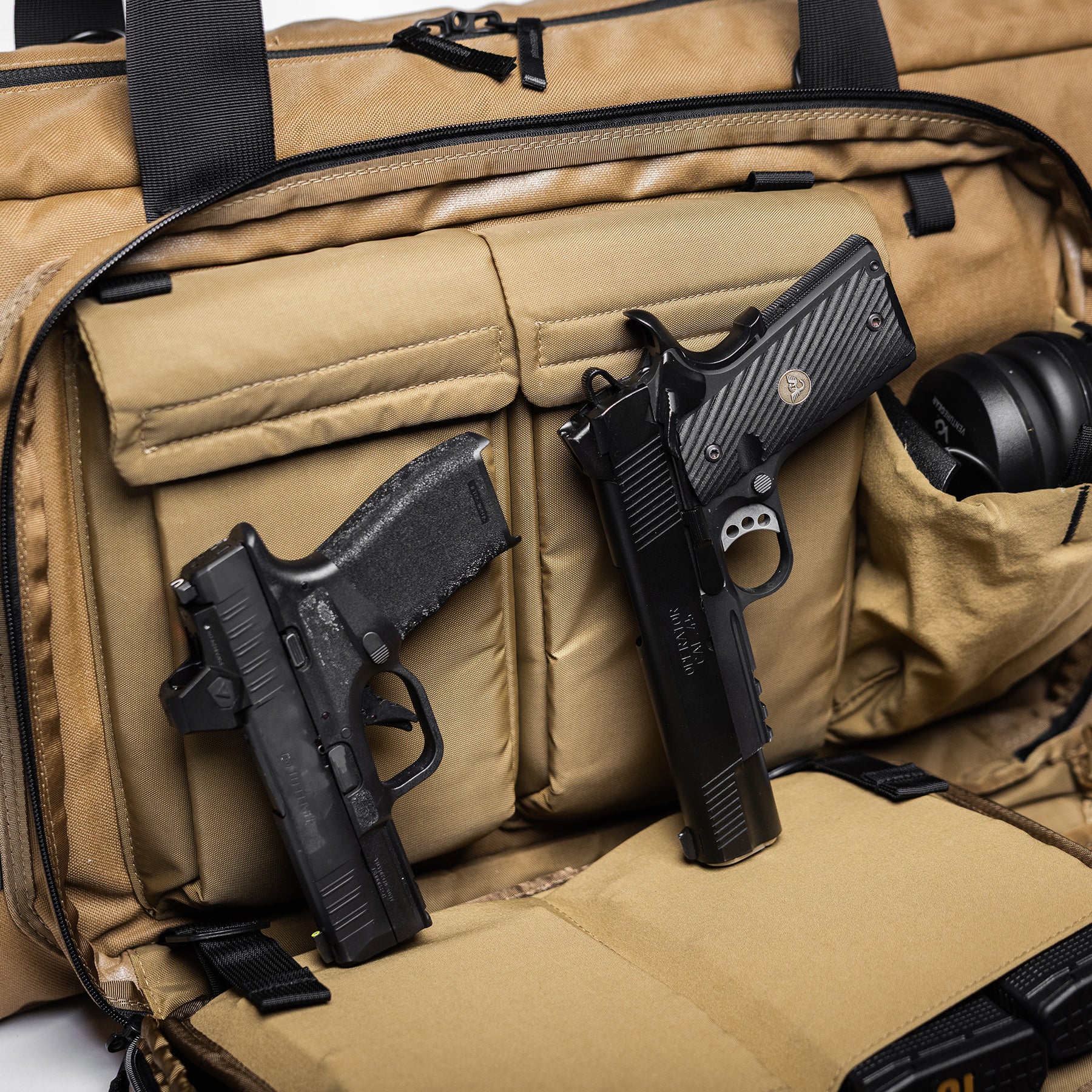 Lone Star 36" rifle bag with two handguns and a pair of headphones stored inside, featuring padded compartments and secure straps.