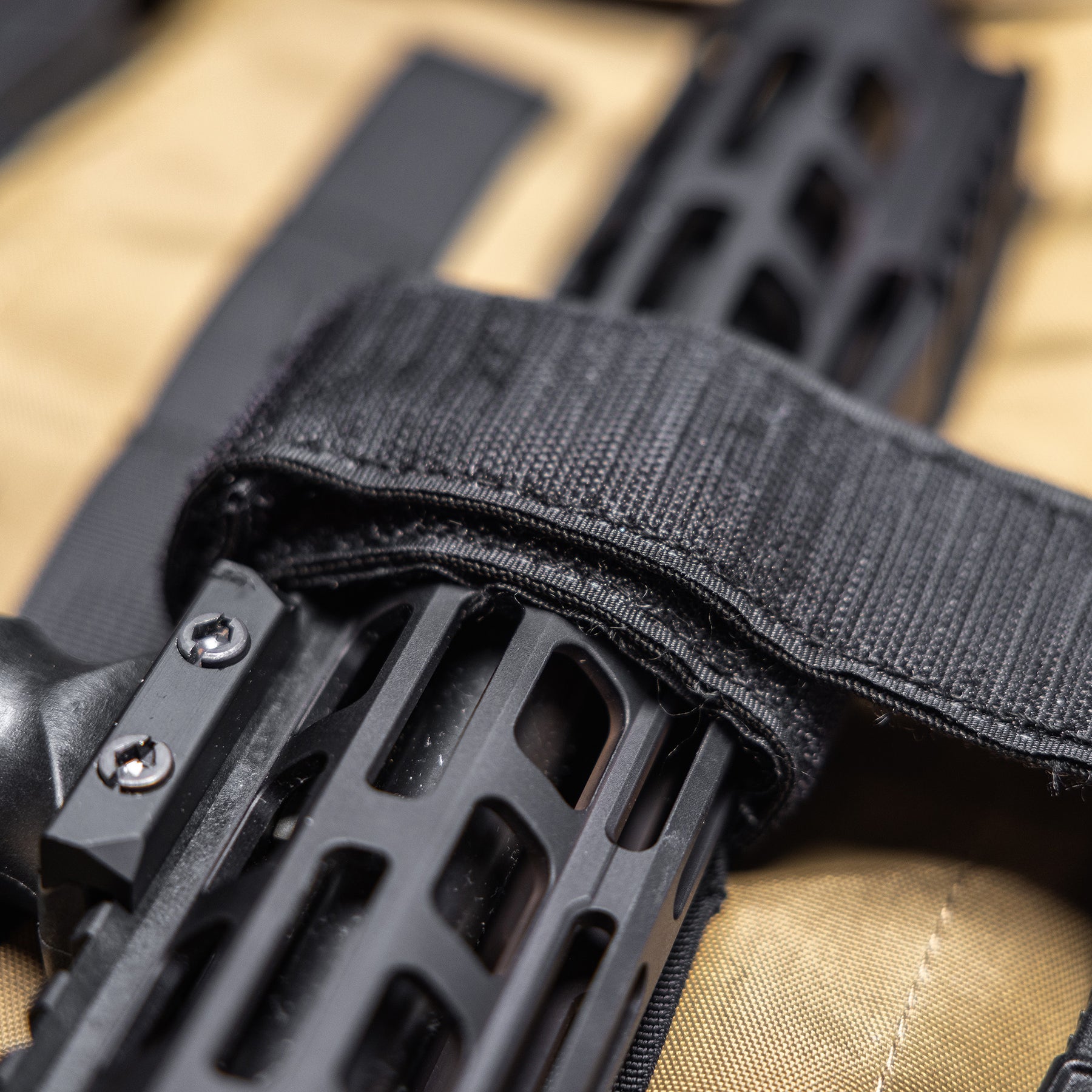 Close-up of a black rifle inside a 36-inch Lone Star rifle bag with padded strap and durable fabric.