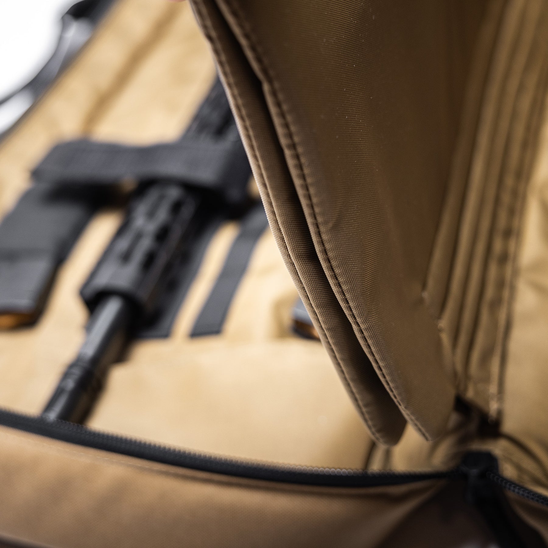 Close-up of a tan Lone Star 36" rifle bag with padded interior and black zipper, designed for firearm transportation and storage.
