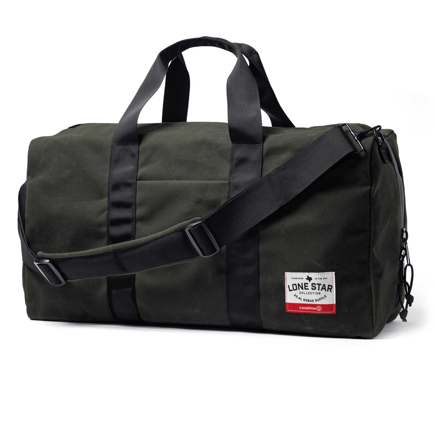The GOBAG Waxed Canvas Duffle bag in dark green with black straps, handles, and adjustable shoulder strap, featuring a front label.