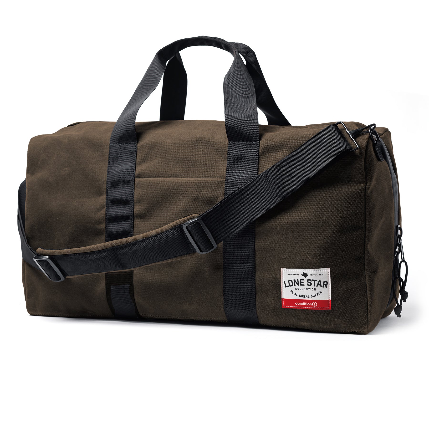 The GOBAG Waxed Canvas Duffle bag in olive green with black straps, handles, and adjustable shoulder strap, featuring a front label.