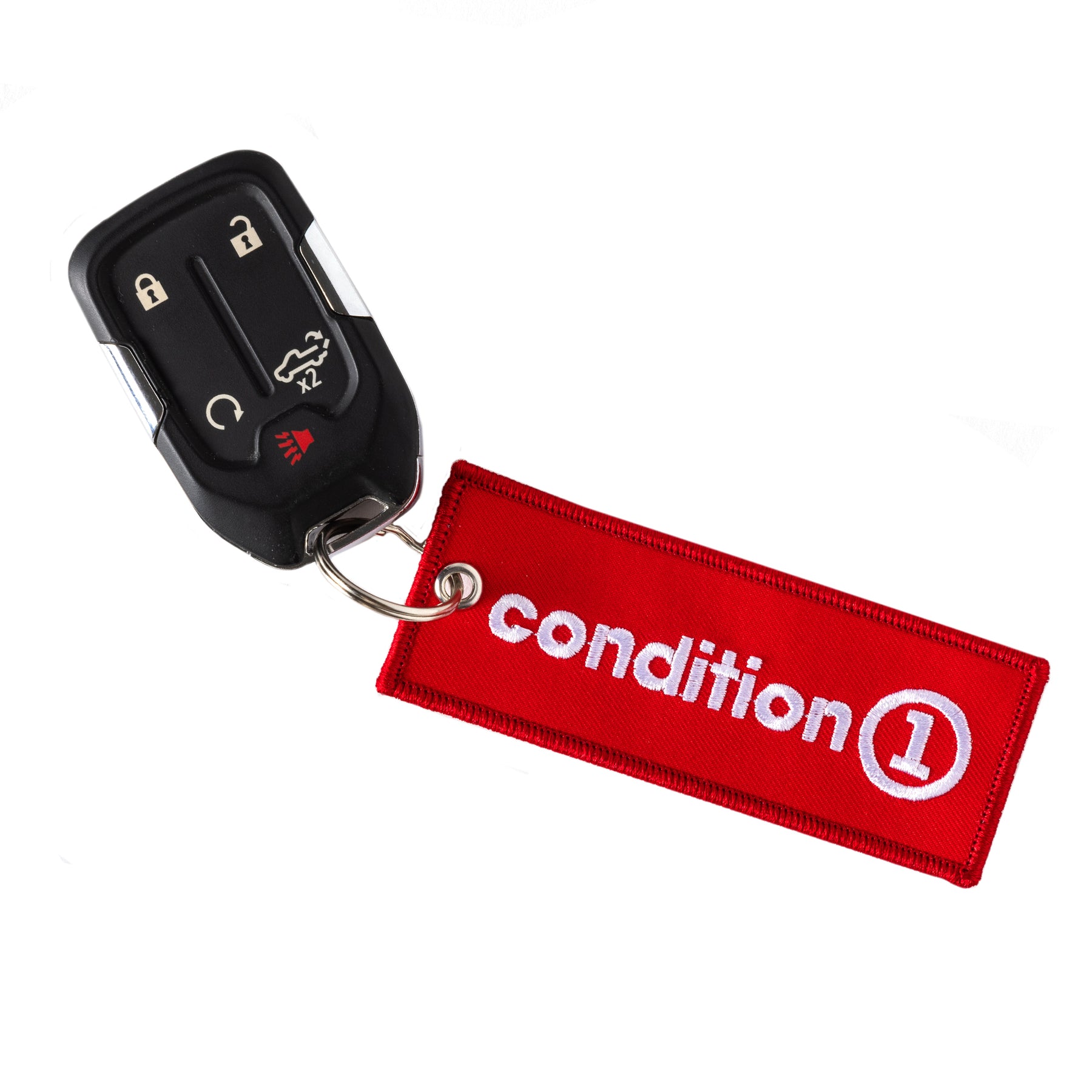 Black car key fob attached to a red fabric keychain with "condition 1" embroidered in white.