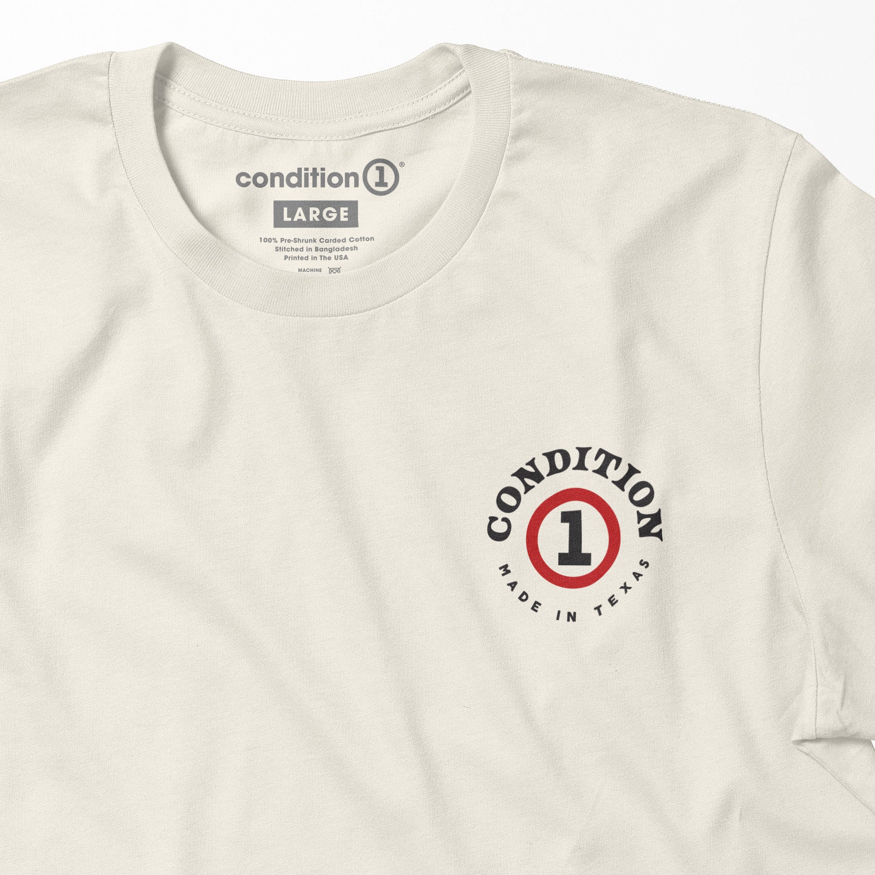 Cream-colored "Like A Tank" tee featuring a circular logo with "Condition 1" and "Made in Texas" text, casual and stylish.