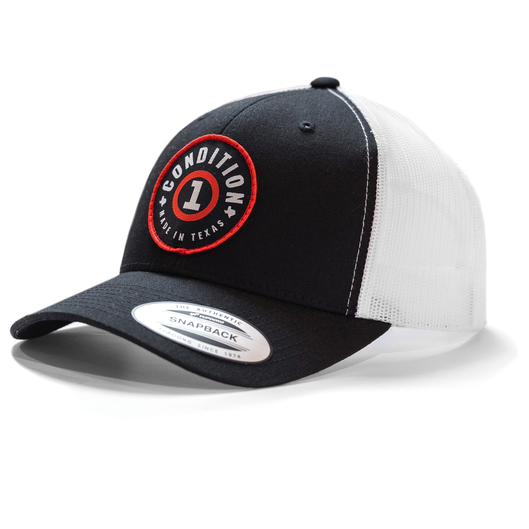 Black and white snapback cap with a circular embroidered patch reading "Condition 1 Made in Texas" on the front.