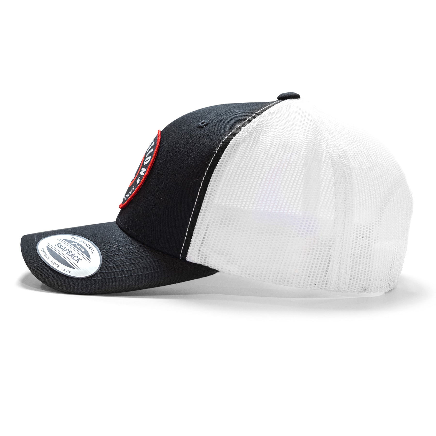 Black and white snapback cap with a curved brim, mesh back panels, and a circular patch on the front.