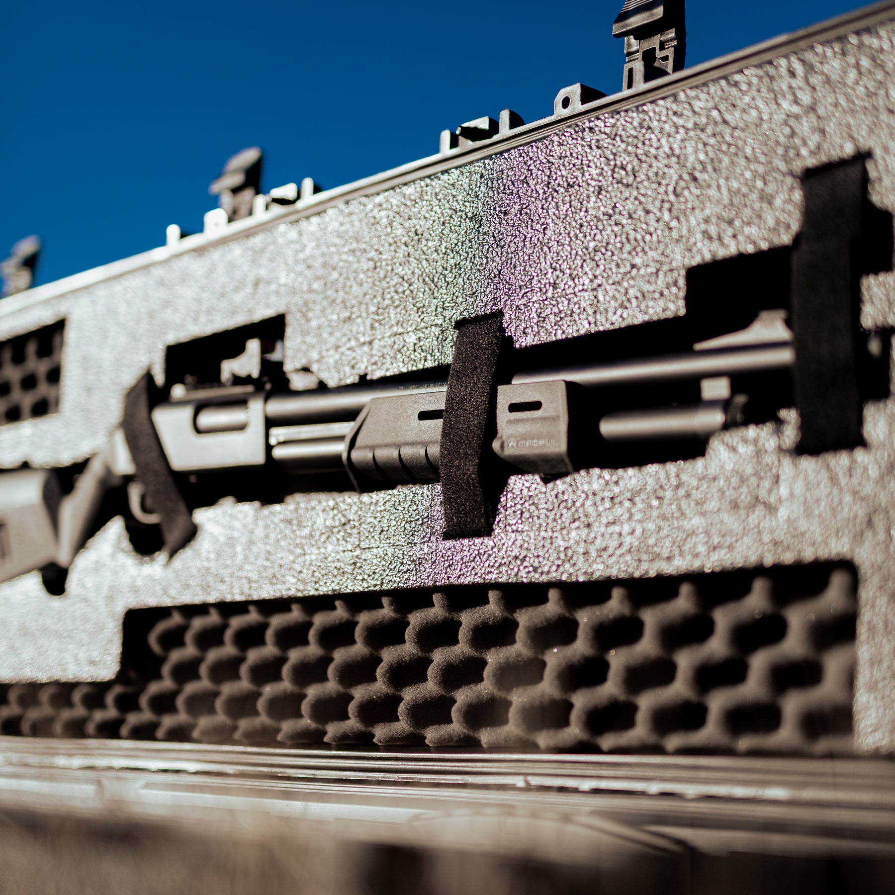 Close-up of a 55-inch 3 gun case with foam padding and foam inserts, designed to protect firearms during transport.
