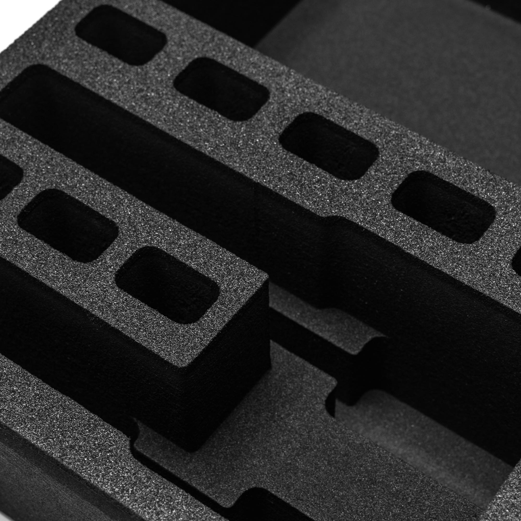 Pre-cut foam insert for #179 case, featuring two slots for magazines and eight additional cutouts for secure storage.