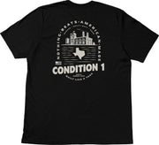 Black American-made T-shirt featuring a graphic of a factory, Texas outline, and text emphasizing quality and durability.