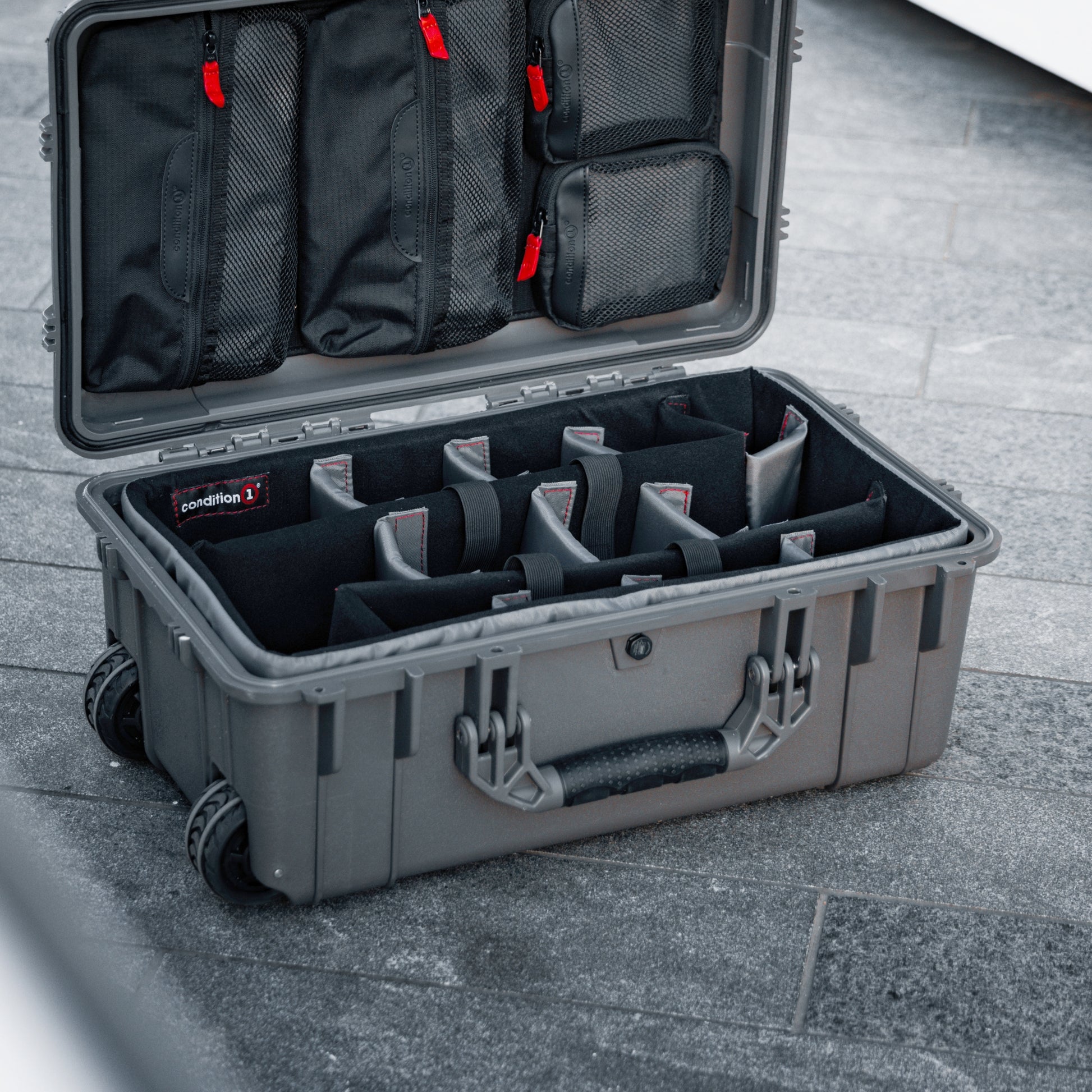 Padded divider set inside a gray protective case for organizing equipment in a #300 case, with adjustable compartments and mesh pockets.