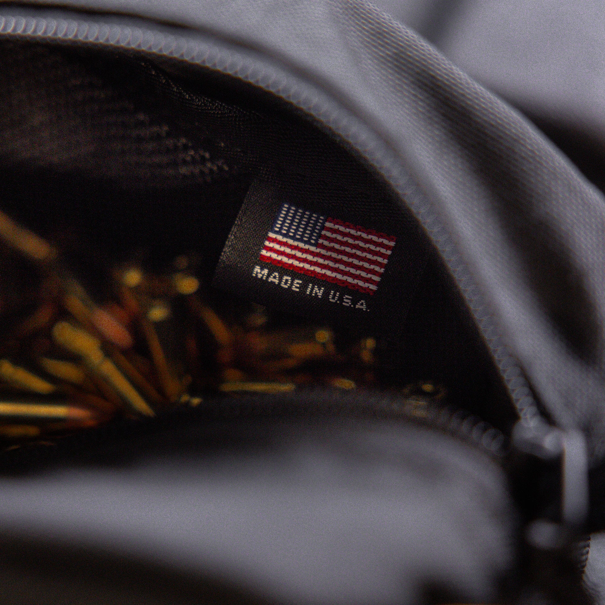 Close-up of a black Lone Star Ammo Bag interior with a label indicating it is made in the USA, partially showing ammunition inside.