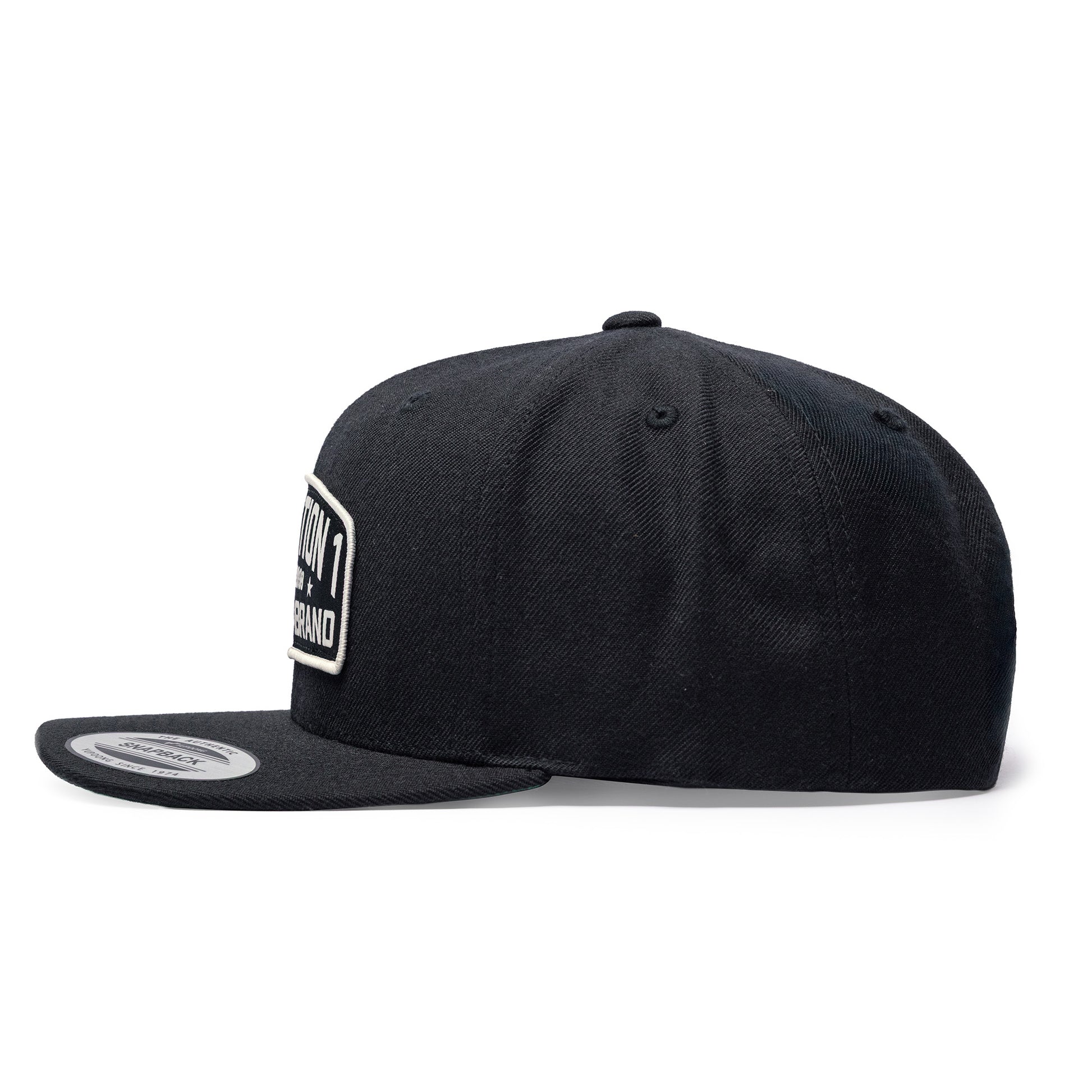 Black Texas Brand snapback cap featuring a flat brim and embroidered logo on the front, viewed from the side.