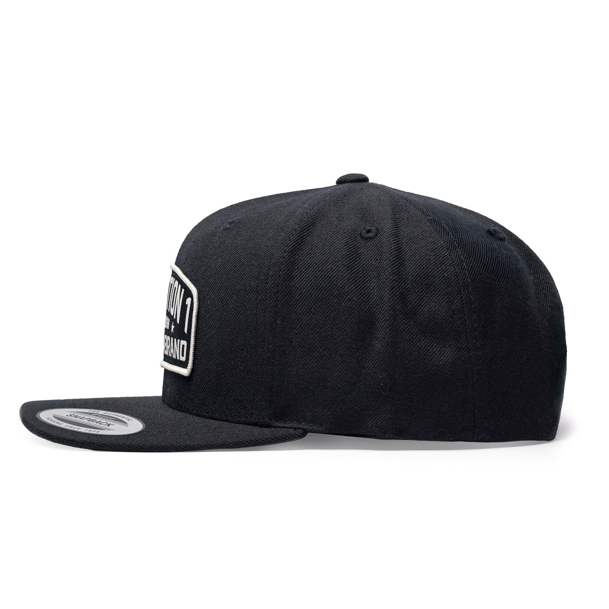 Black Texas Brand snapback cap featuring a flat brim and embroidered logo on the front, viewed from the side.