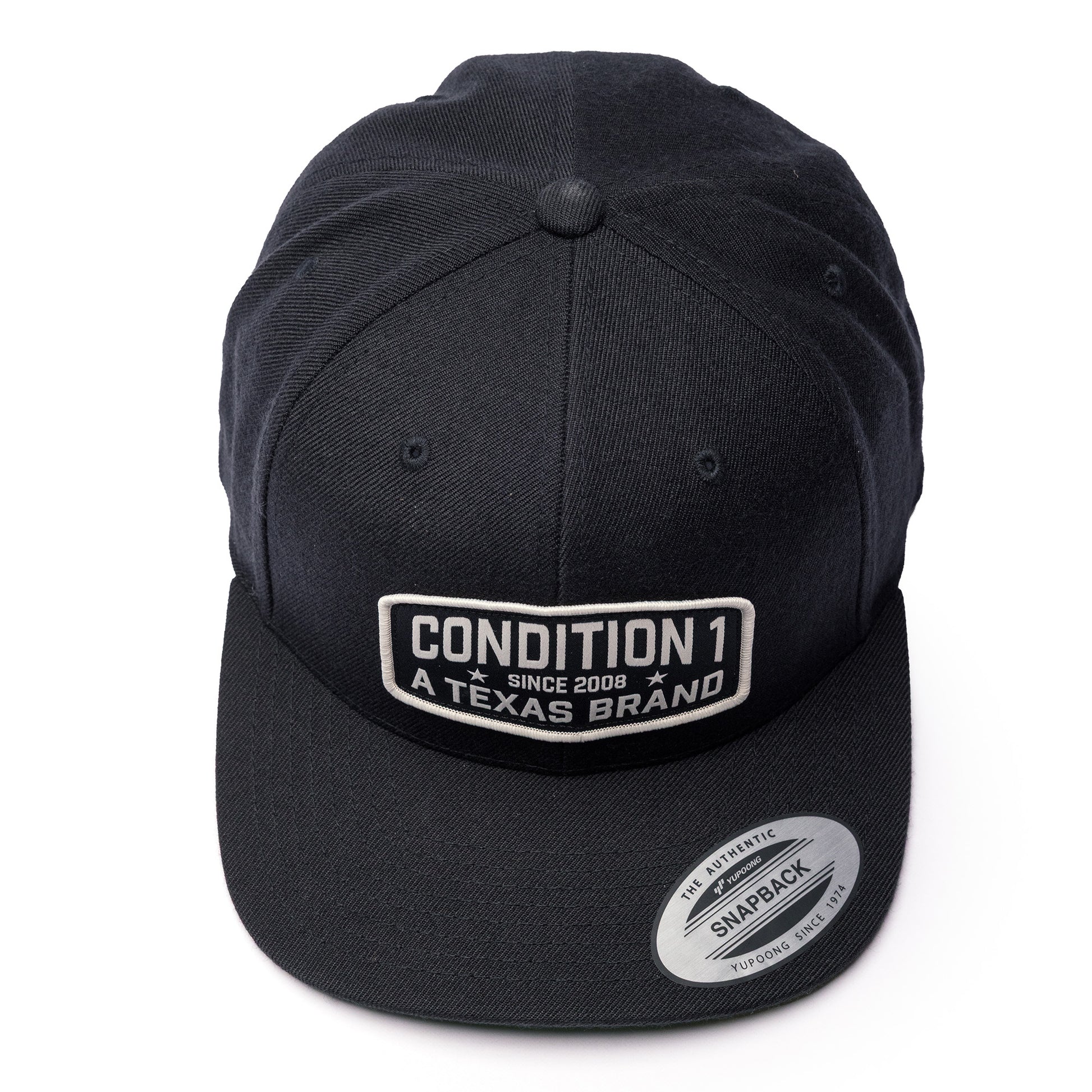 Black Texas Brand snapback hat featuring a rectangular patch with the text "Condition 1 Since 2008 A Texas Brand" on the front.