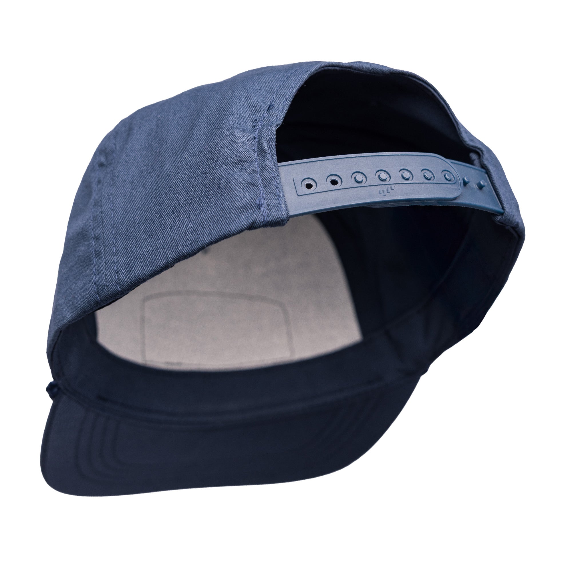Unstructured snapback cap in navy blue with an adjustable strap and a soft inner lining for comfort.