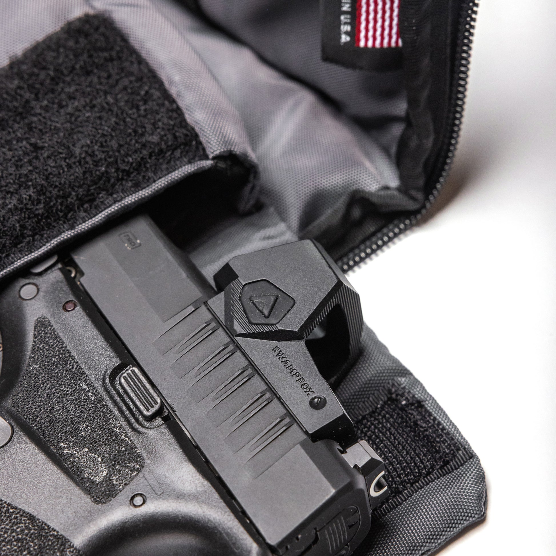 Inside a Lone Star 2 Pistol Bag, a handgun with a mounted sight is securely stored, ready for transport or storage.