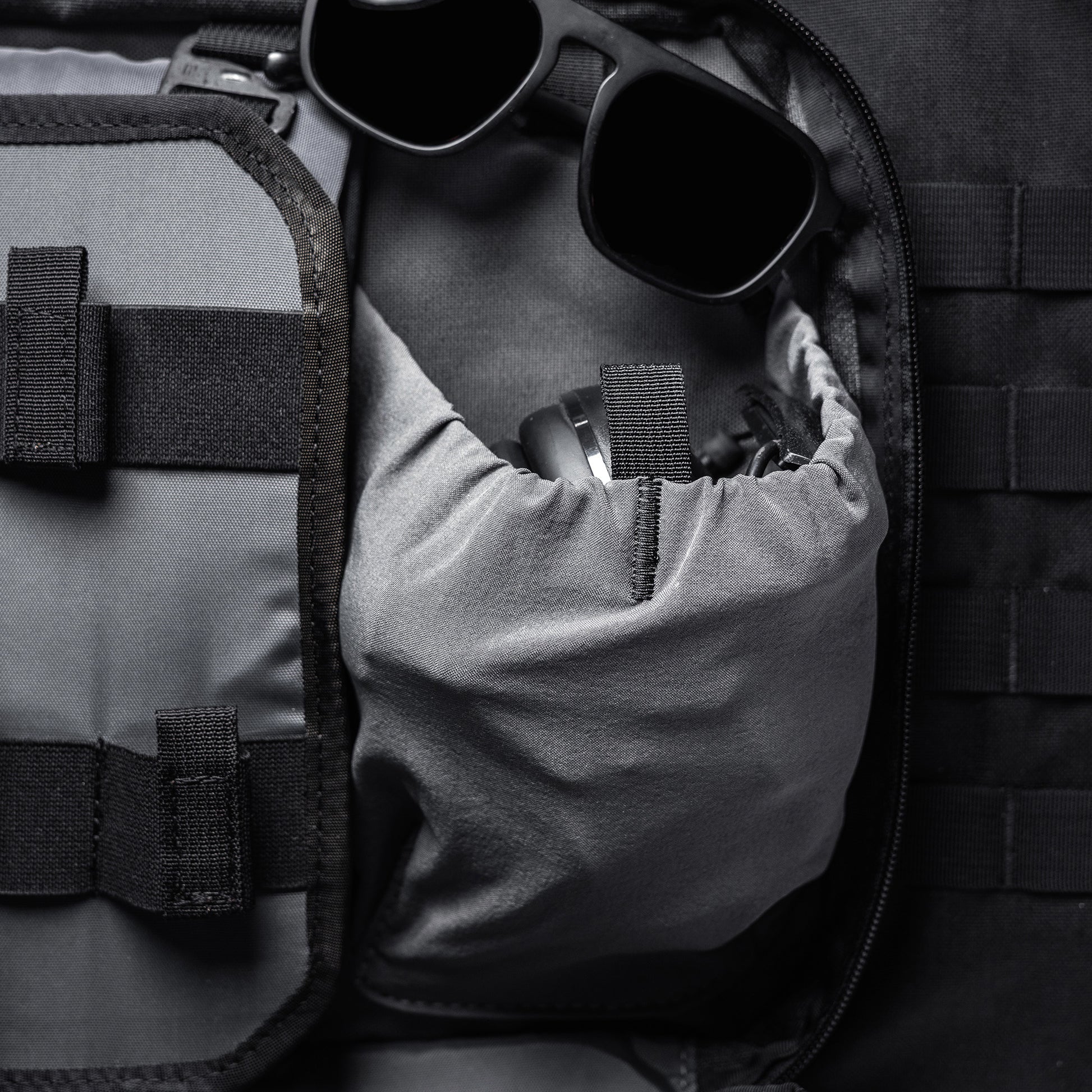A black and gray Lone Star 36" rifle bag with a zippered compartment, holding sunglasses and a small accessory inside.