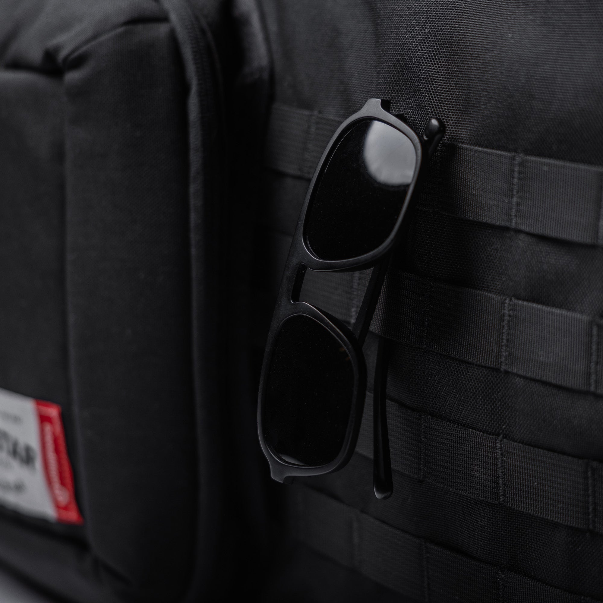 Black Lone Star 36" rifle bag with sunglasses attached to the exterior, made of durable fabric with MOLLE webbing.