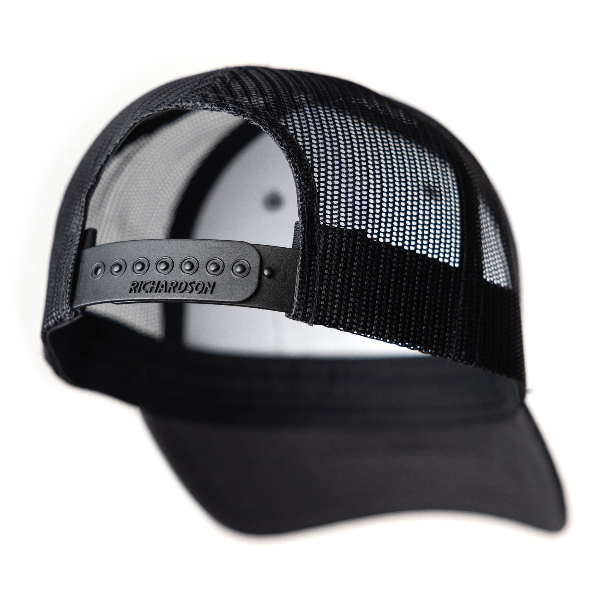 Black snapback cap with a mesh back and adjustable strap, featuring the brand name "RICHARDSON" on the closure.