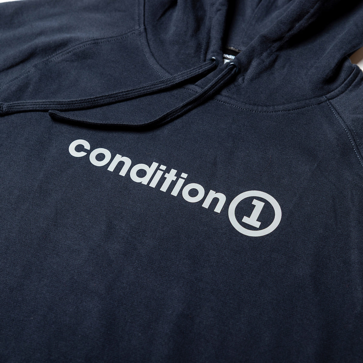 Black hoodie featuring the "condition 1" logo prominently displayed in white across the chest.