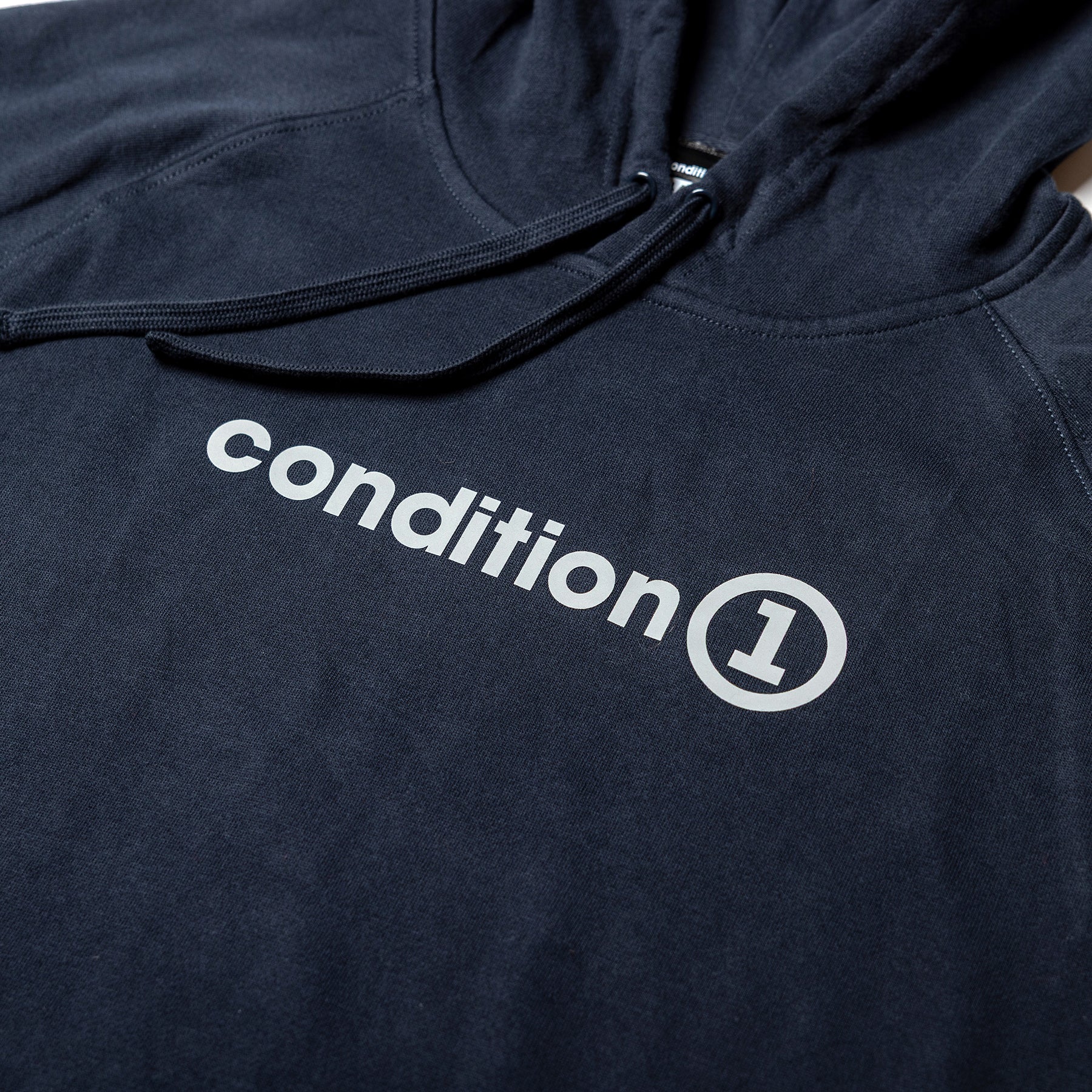 Black hoodie featuring the "condition 1" logo prominently displayed in white across the chest.