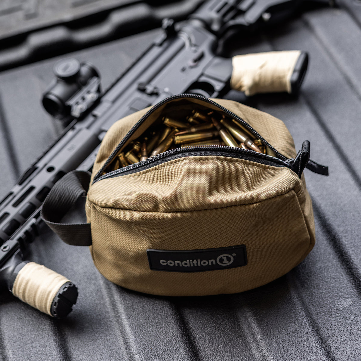 Lone Star Ammo Bag with an open zipper revealing ammunition inside, placed beside a firearm on a textured surface.