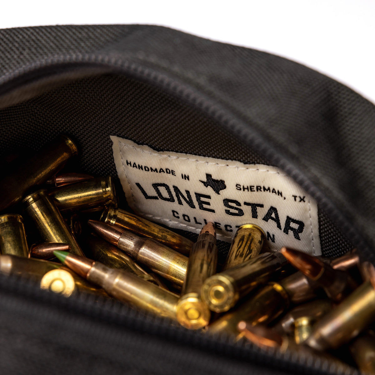 Lone Star Ammo Bag with a label, filled with various ammunition cartridges inside a durable fabric pouch.