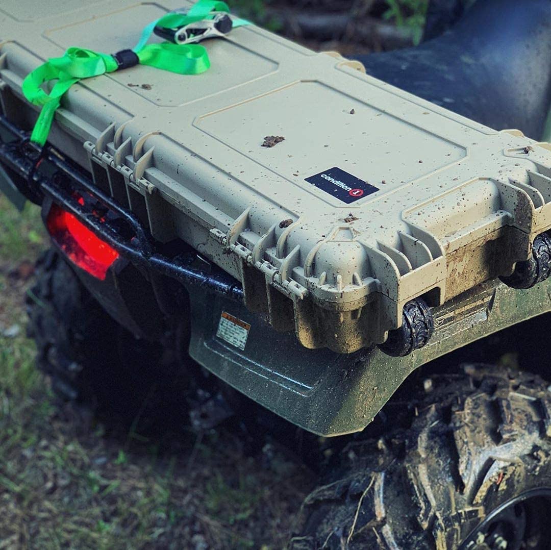 Durable 45" long beige protective case with black handle, secured with green straps, placed on an all-terrain vehicle.